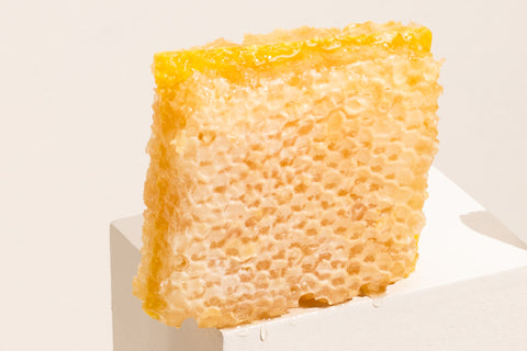 a square cut of honeycomb placed on a square block.