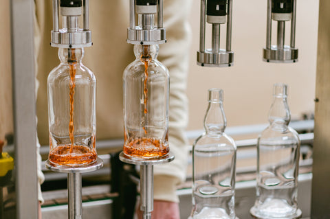 Ferg and Harris whisky being filled into the bottles using a semi-automatic filler 