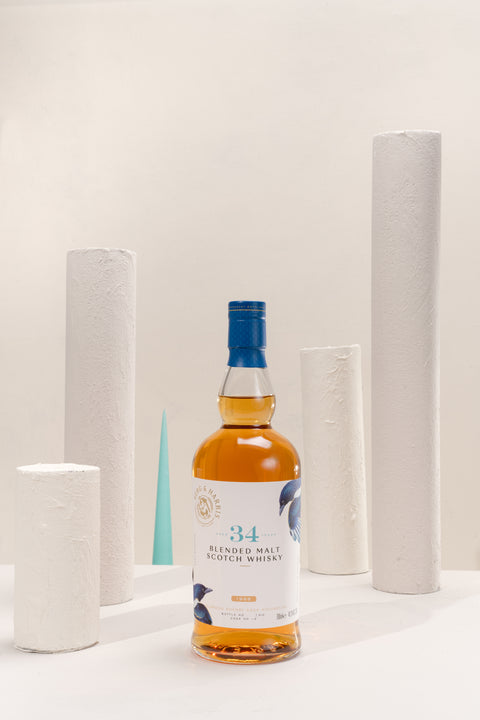 A bottle of Ferg and Harris 34-year-old Blended malt with 4 white columns and 1 light blue spike in the background